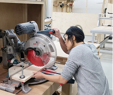 Using a saw in a woodworking workshop